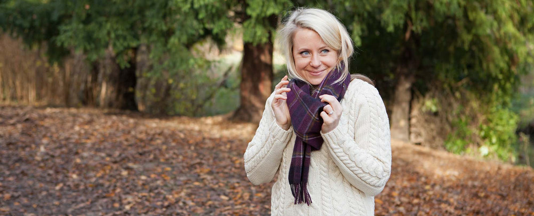 Woman in cashmere scarf and aran jumper