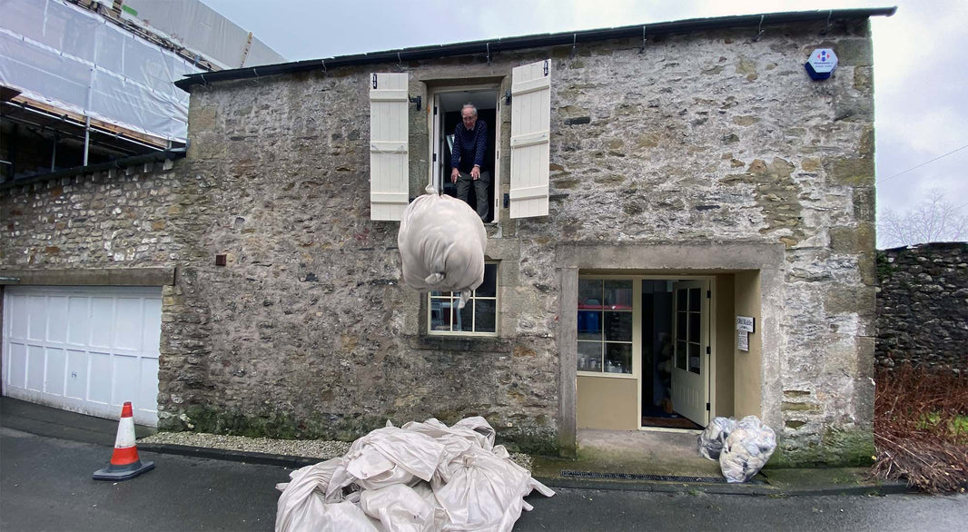 Bales of wool being dropped from the stable hay barn