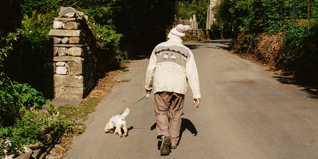 Lady walking dog in British Wool jumper and hat