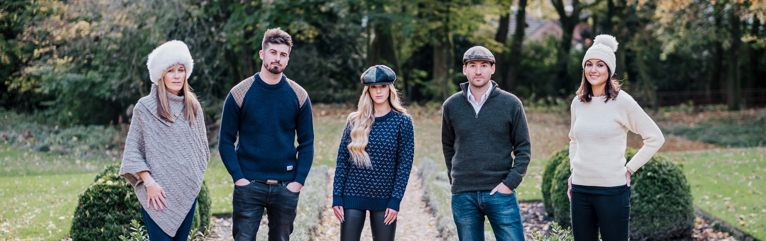 3 women and 2 women lined up in a variety of wool knitwear and tweed hats