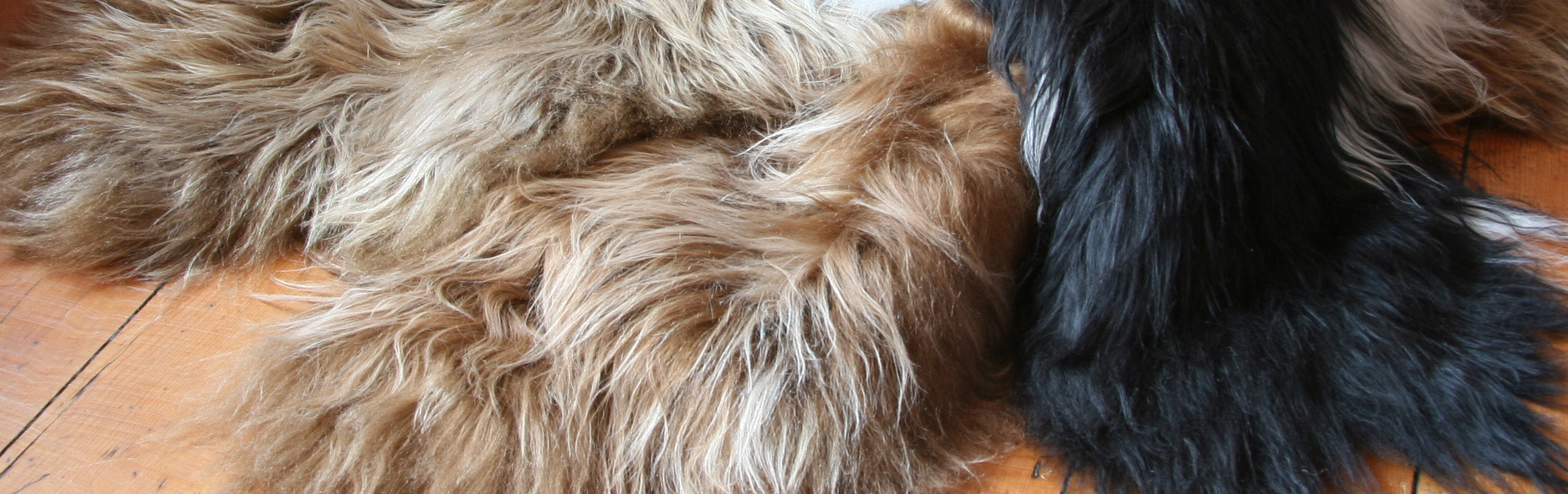 Close up of pile of sheepskin rugs on top of each other