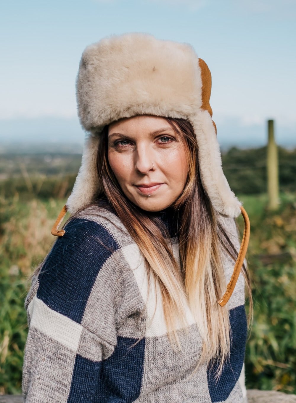 Model wearing sheepskin trapper hat with ties 