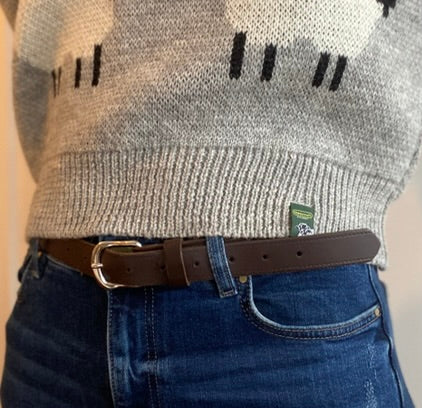 Person wearing a wool jumper, jeans, and a brown leather belt.