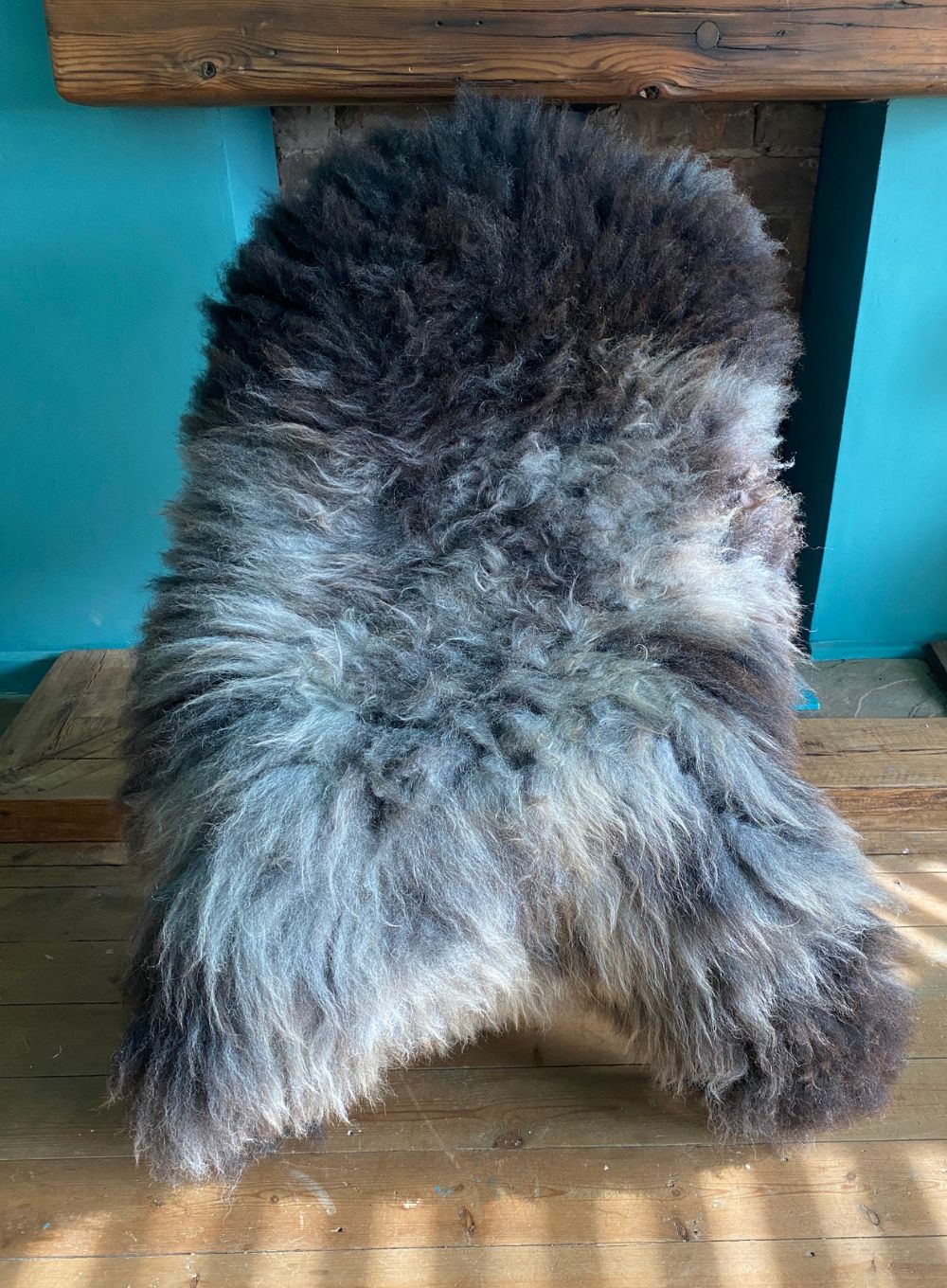 Grey sheepskin rug on chair
