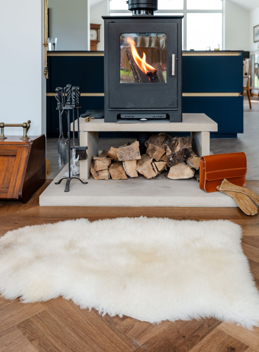 White sheepskin rug in front of fireplace 