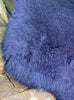 Close up of navy short haired sheepskin rug 