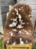 Brown and cream sheepskin rug on chair