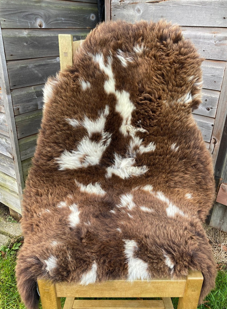 Brown and cream sheepskin rug on chair