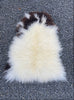 Brown and cream sheepskin on gravel