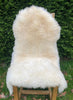 Cream sheepskin rug on chair