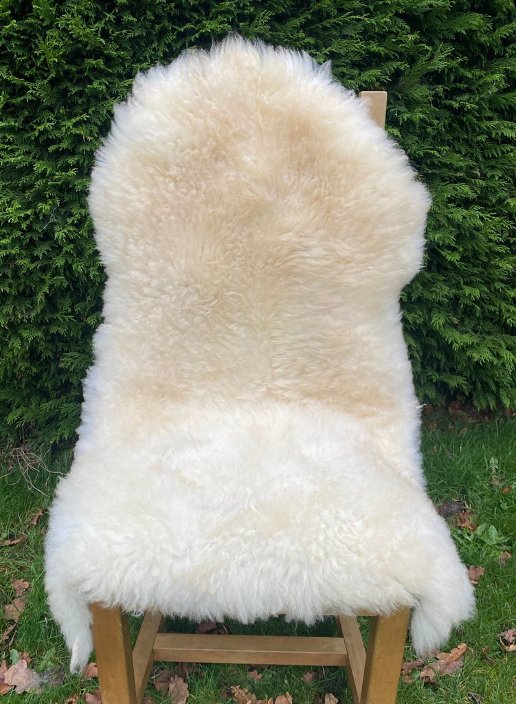 Cream sheepskin rug on chair