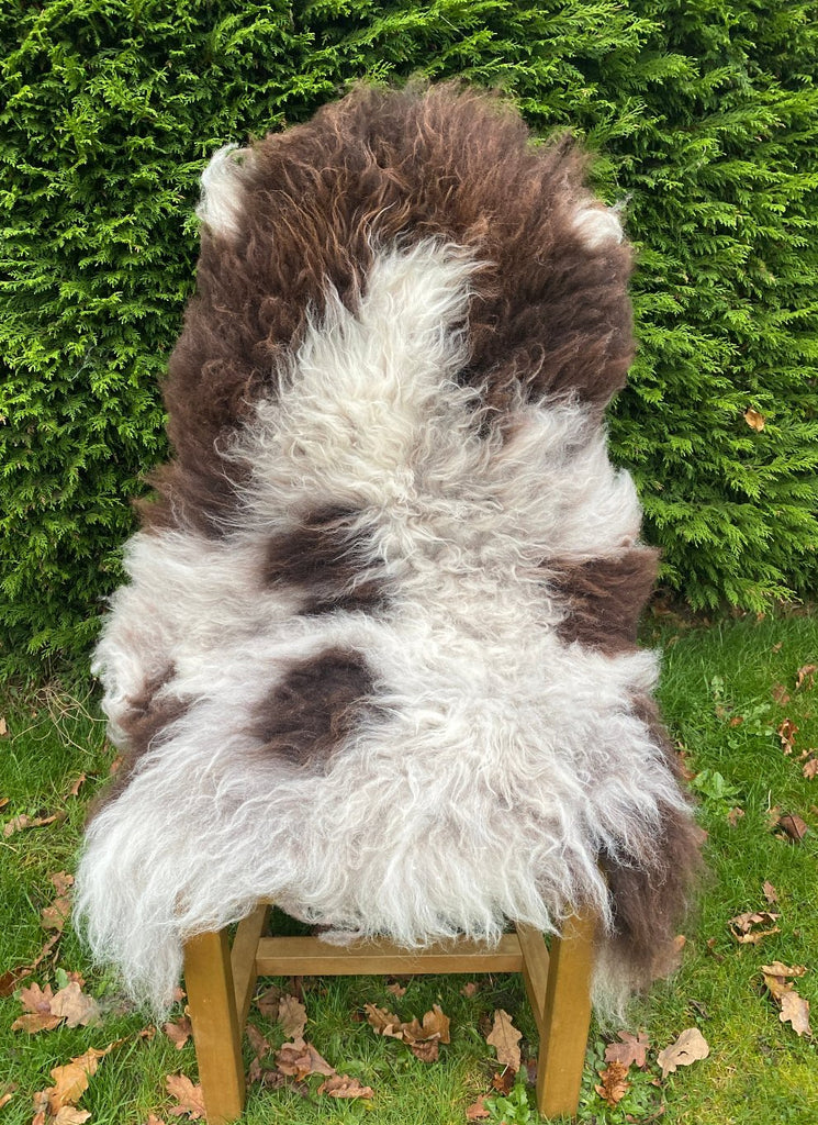 Brown and grey sheepskin rug on chair 