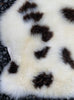 Cream and brown spotty sheepskin rug close up  