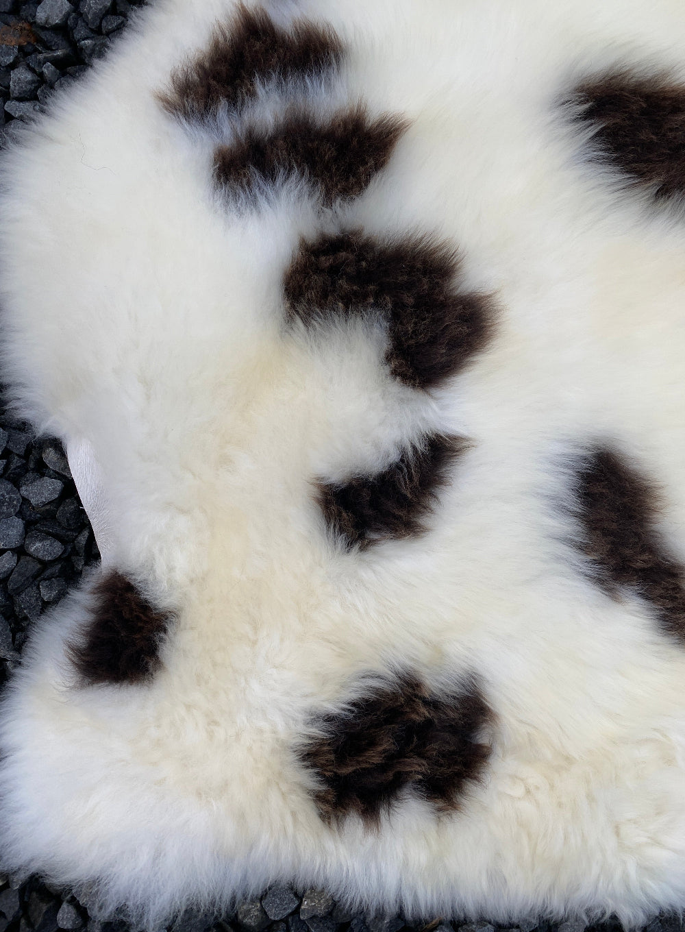 Cream and brown spotty sheepskin rug close up  