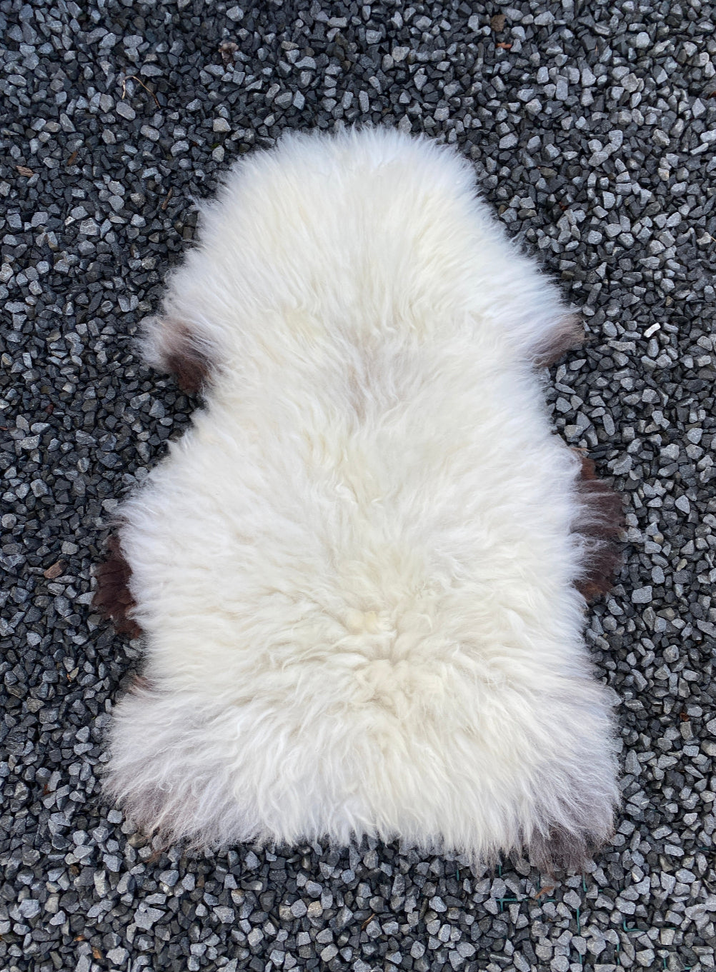 Cream sheepskin on gravel 