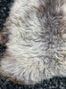 Brown and beige sheepskin rug close up 