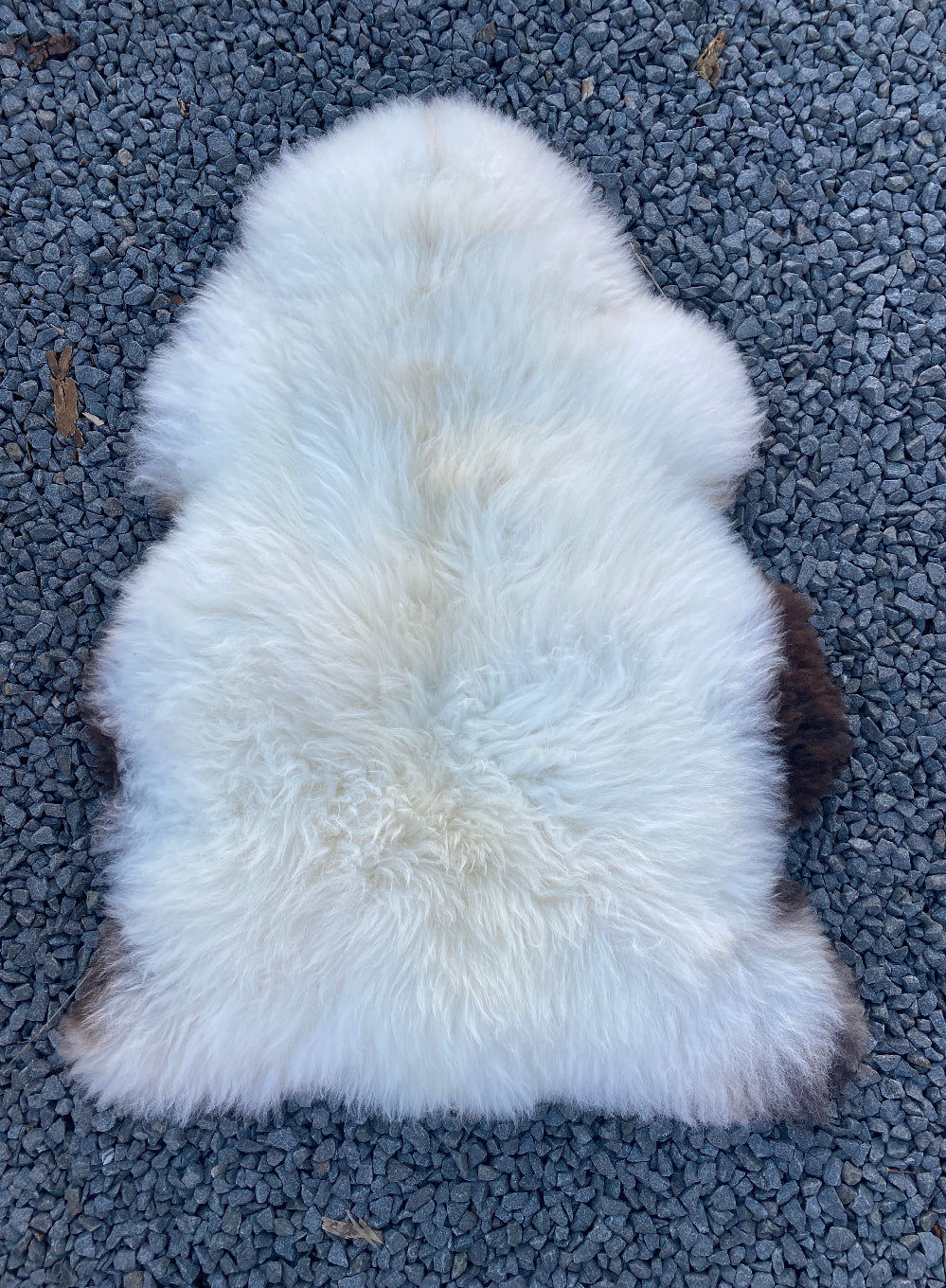 Cream sheepskin rug laid flat 
