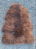 Brown sheepskin rug laid flat