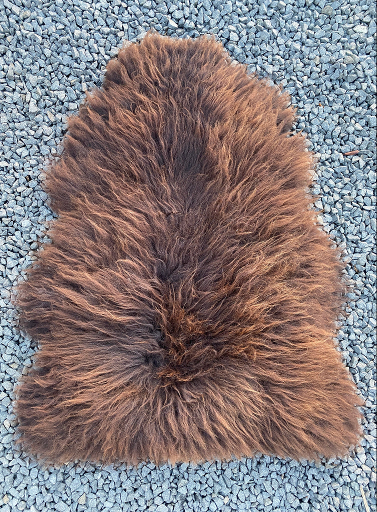 Brown sheepskin rug laid flat