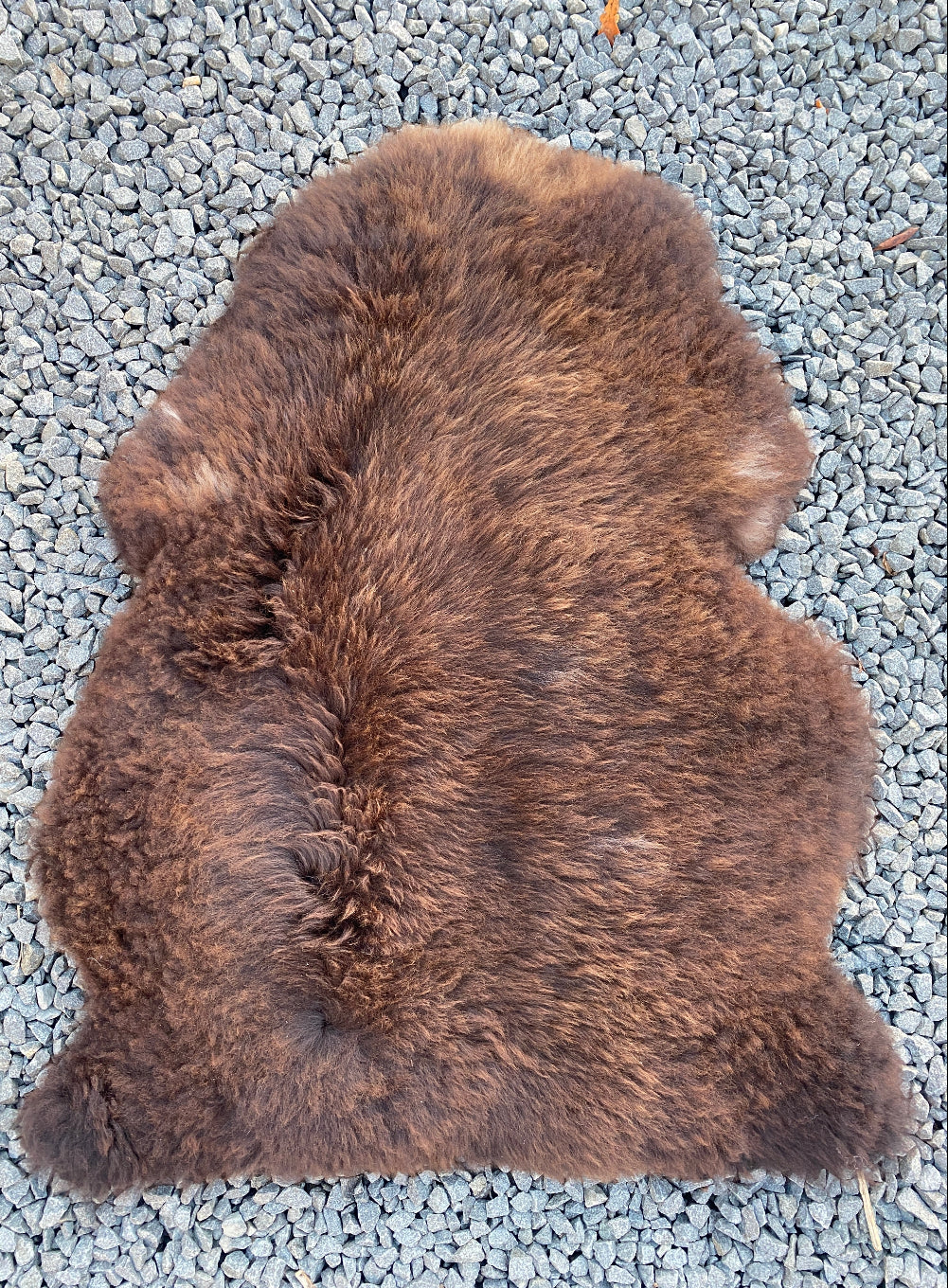 Dark brown sheepskin rug laid flat