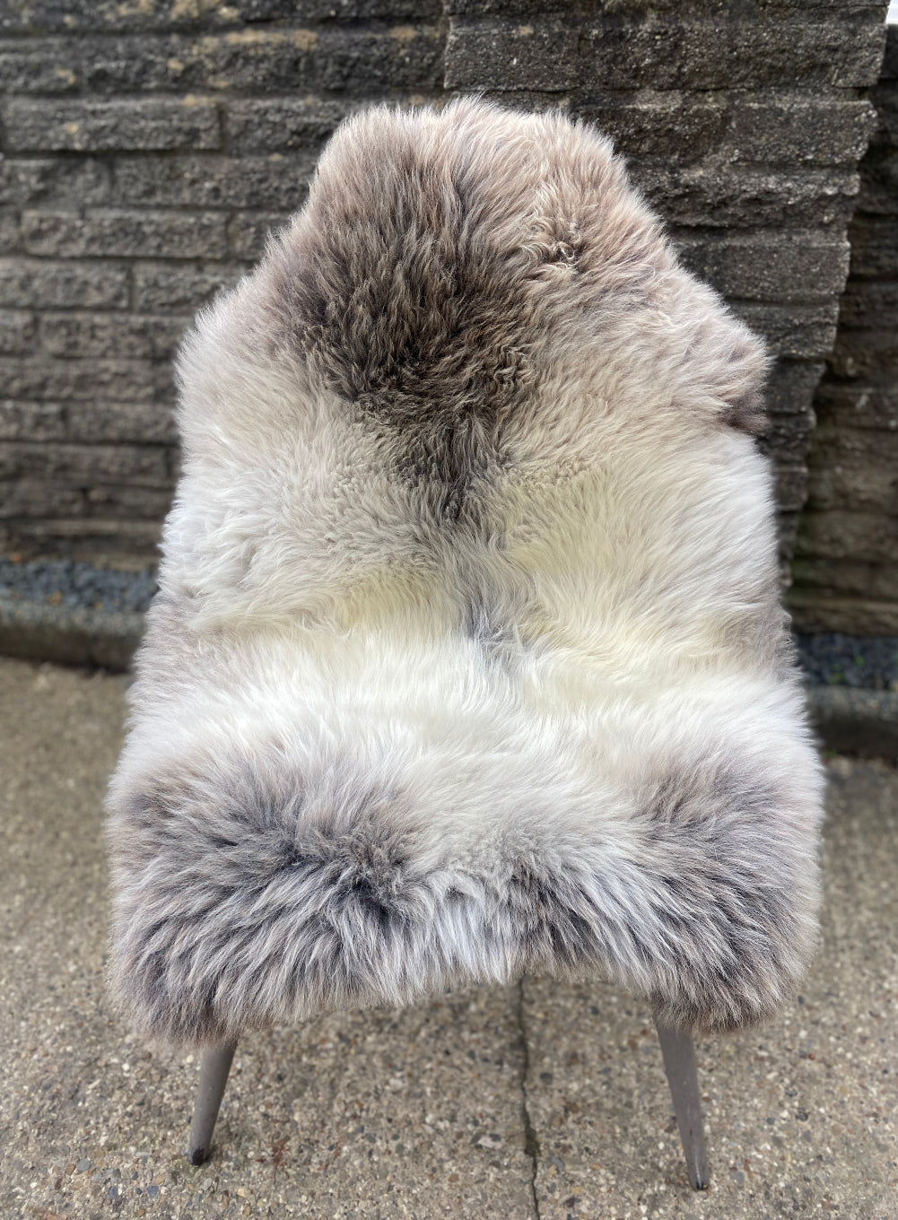 Grey and brown sheepskin rug on chair