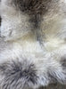 Grey sheepskin rug close up 
