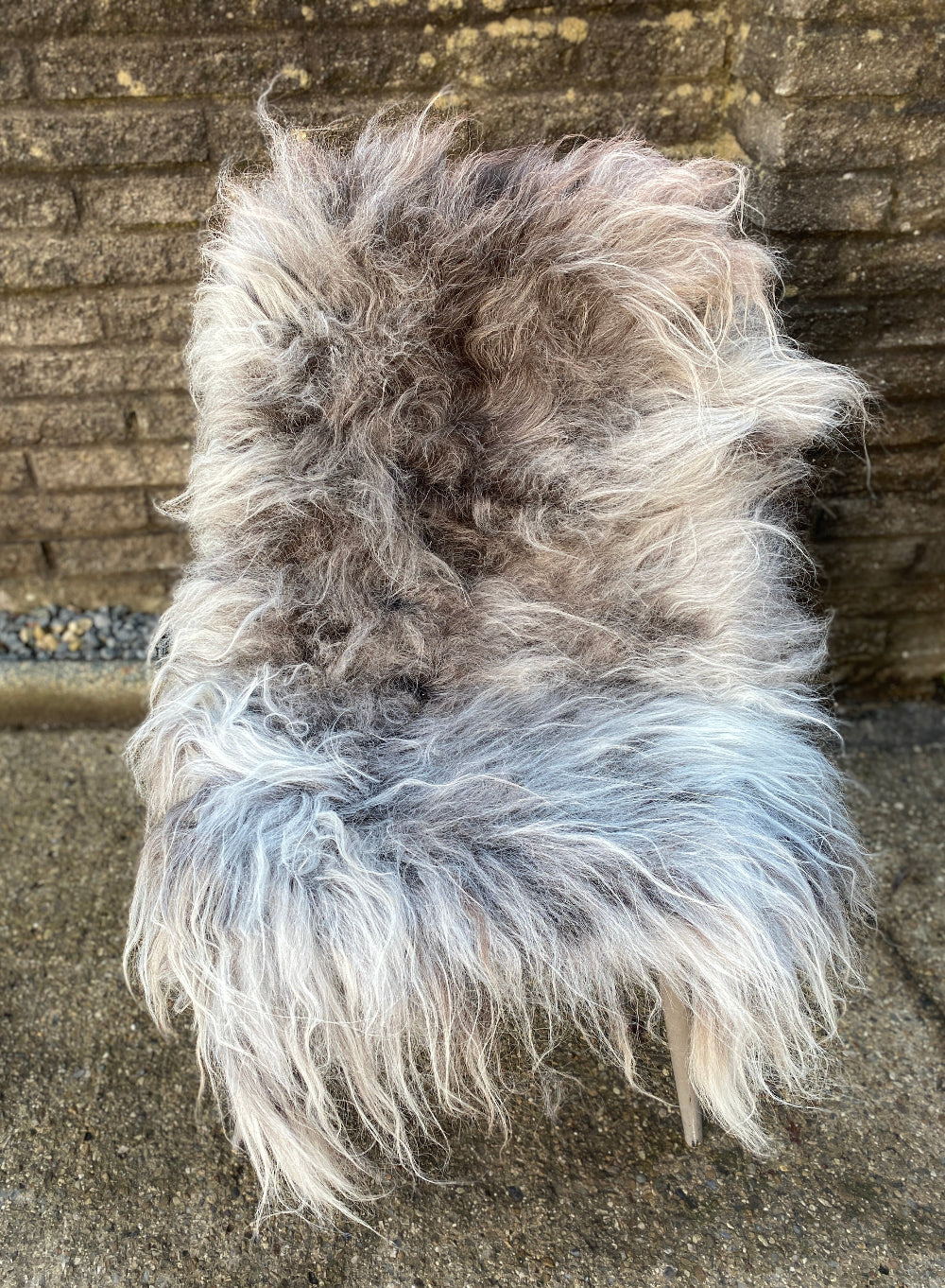 Grey sheepskin rug on chair