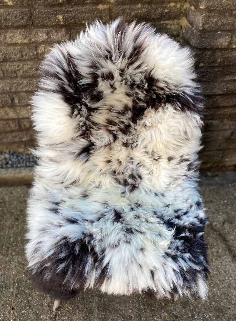 Brown and cream sheepskin rug on chair