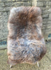 Brown and grey sheepskin rug on chair