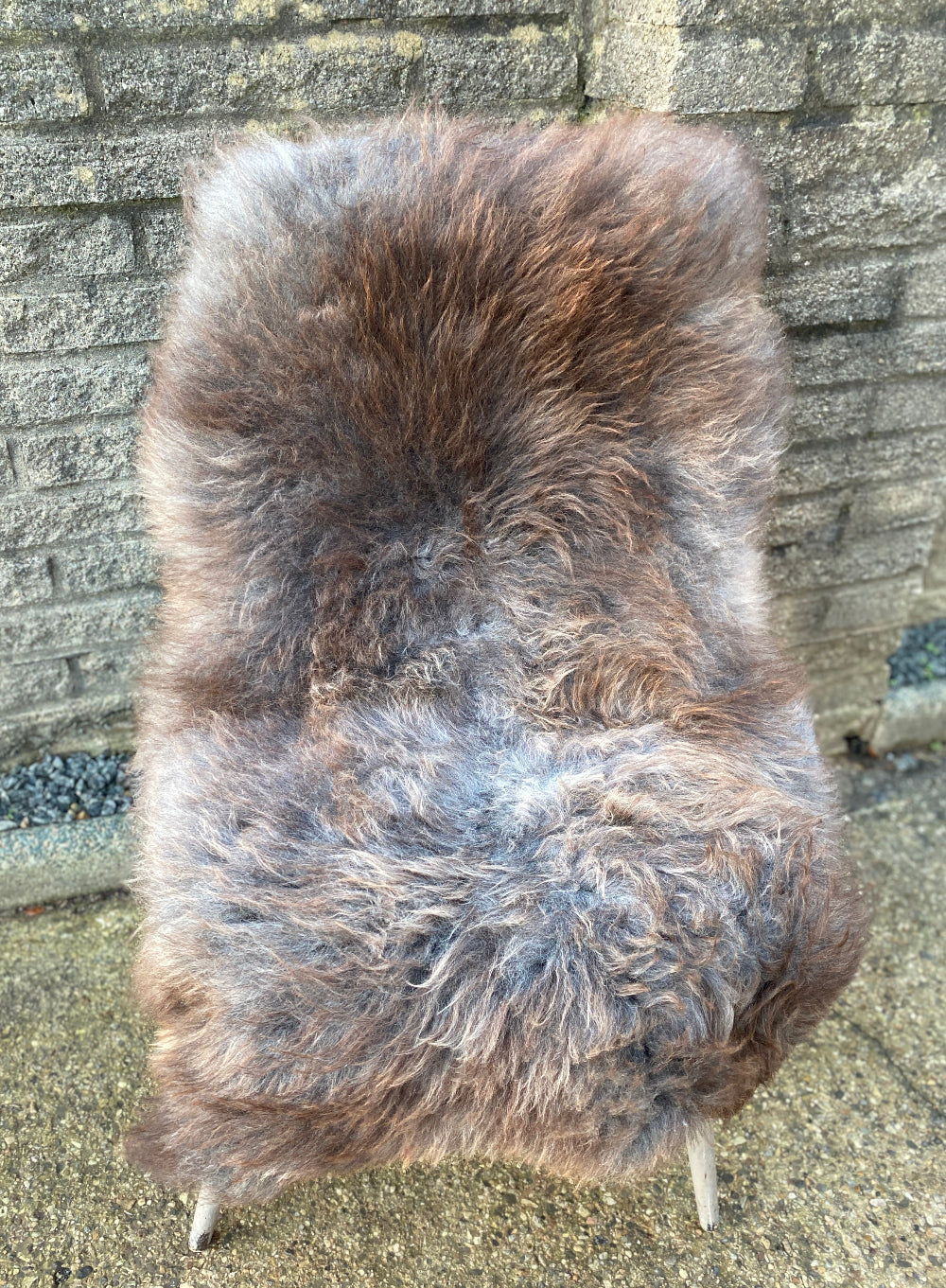 Brown and grey sheepskin rug on chair