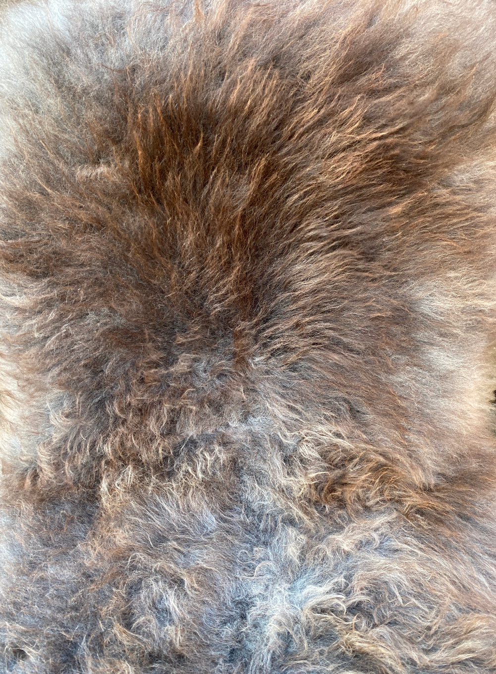 Brown and grey sheepskin rug close up 