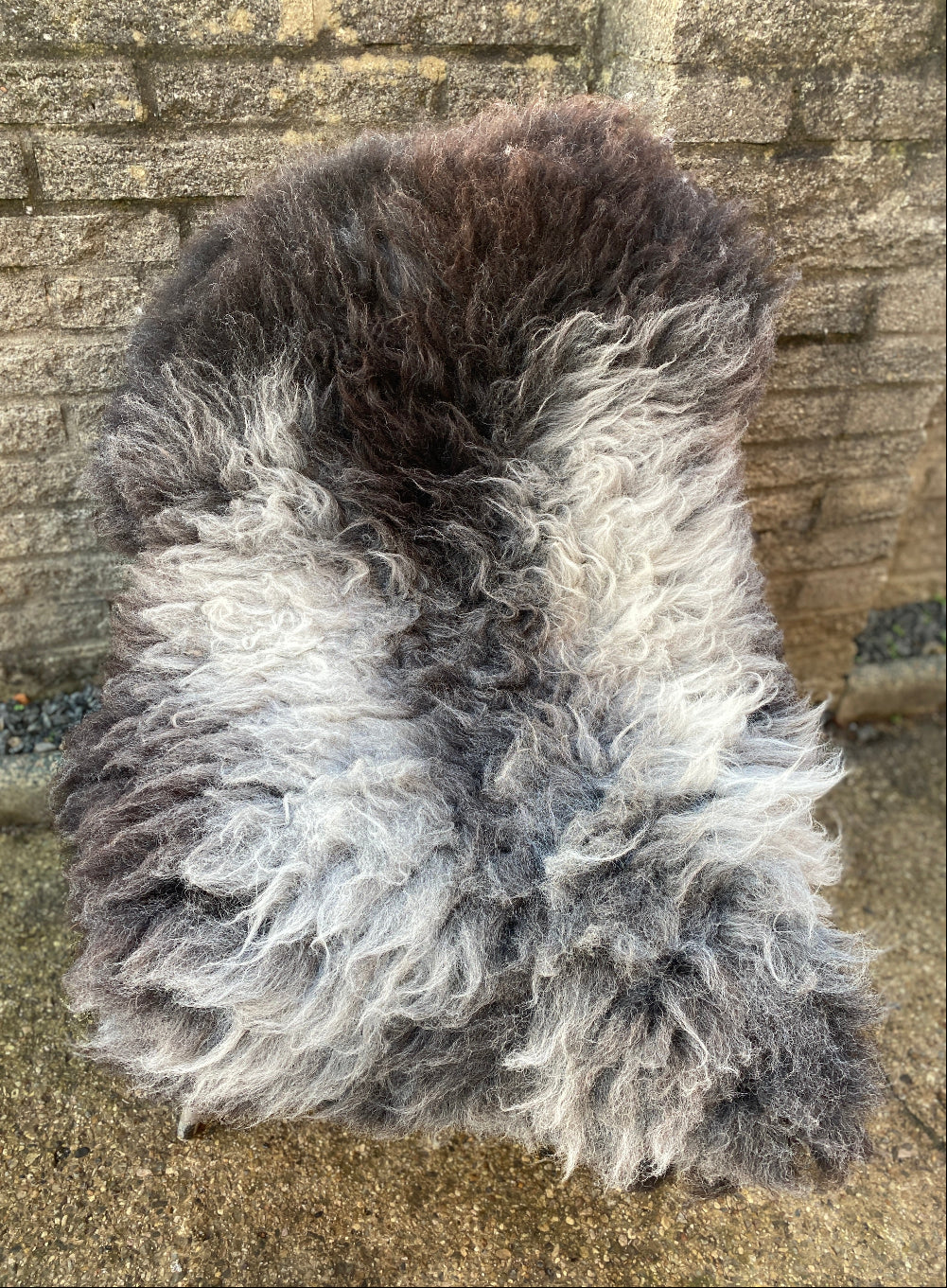 Grey sheepskin rug on chair