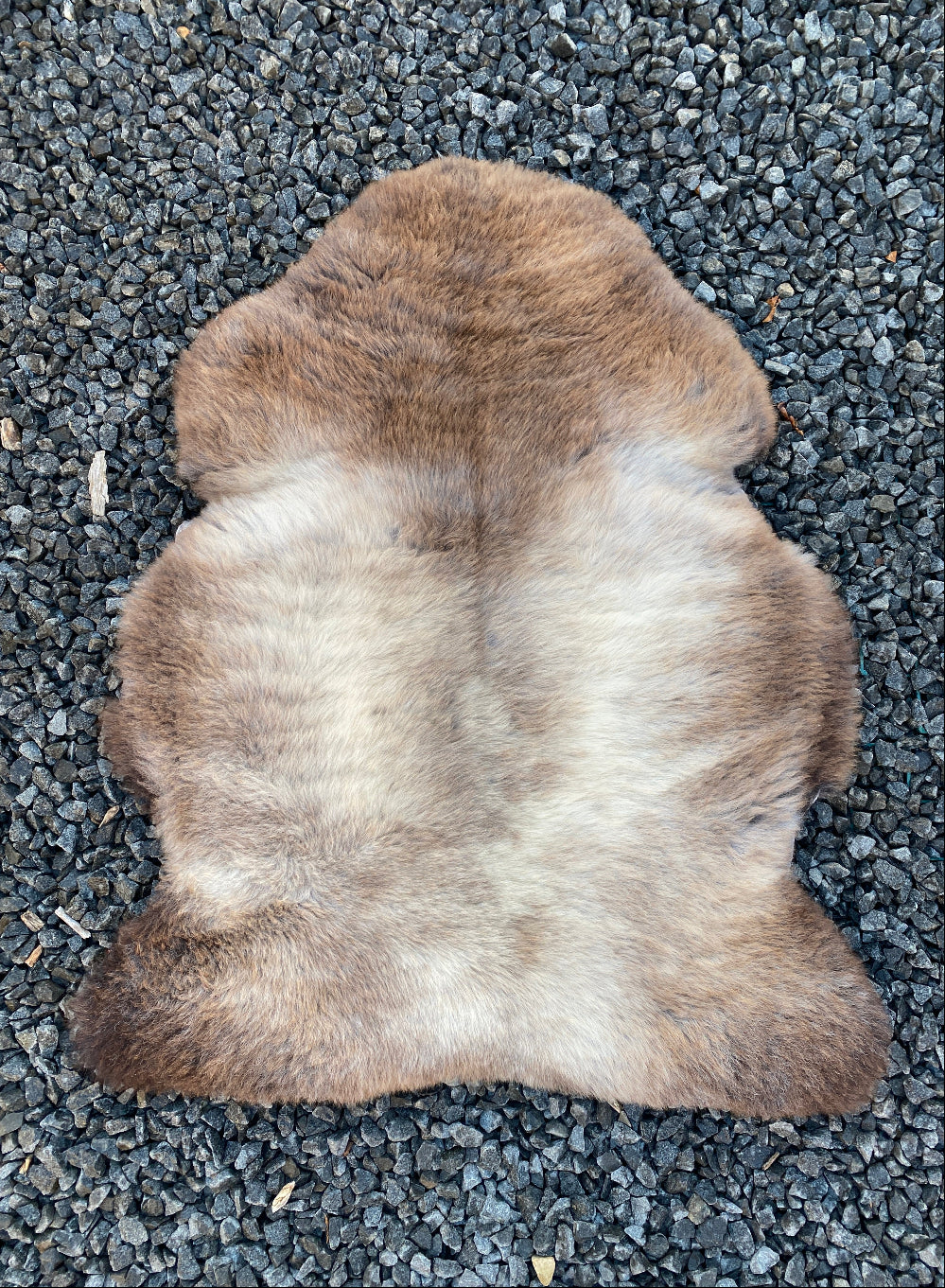 Brown and cream sheepskin rug laid flat