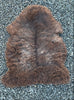 Brown sheepskin rug laid flat 