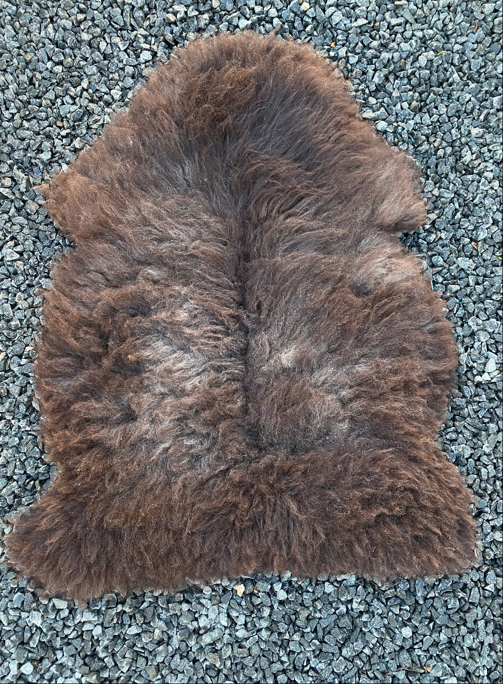 Brown sheepskin rug laid flat 