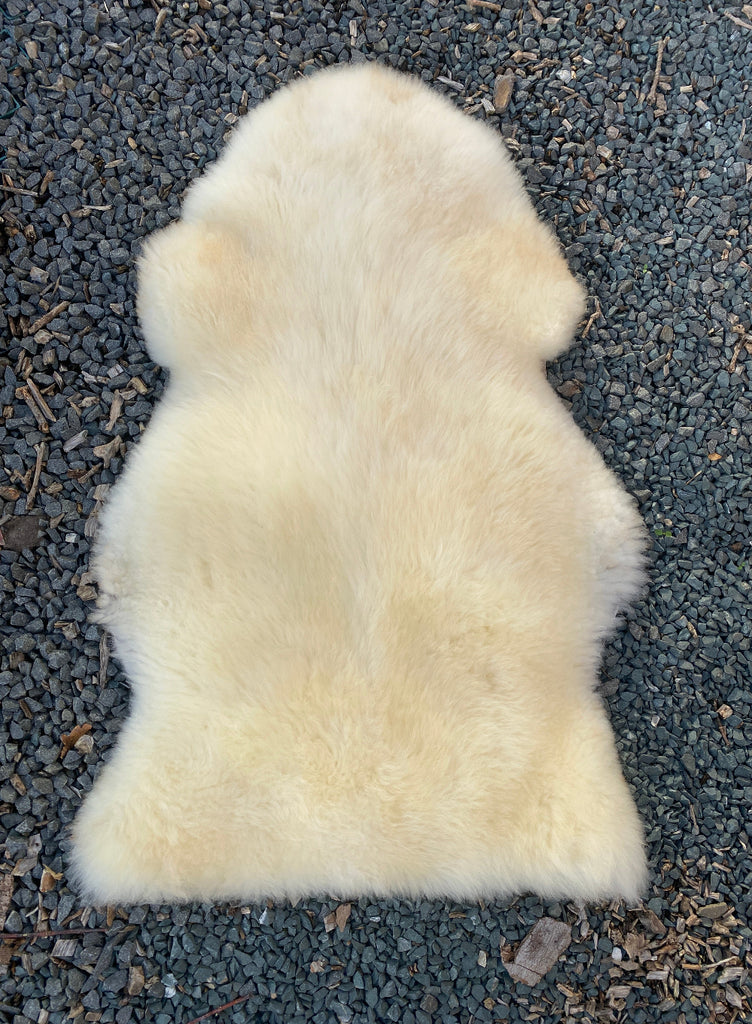 Cream sheepskin rug laid flat
