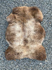 brown and cream sheepskin rug laid flat