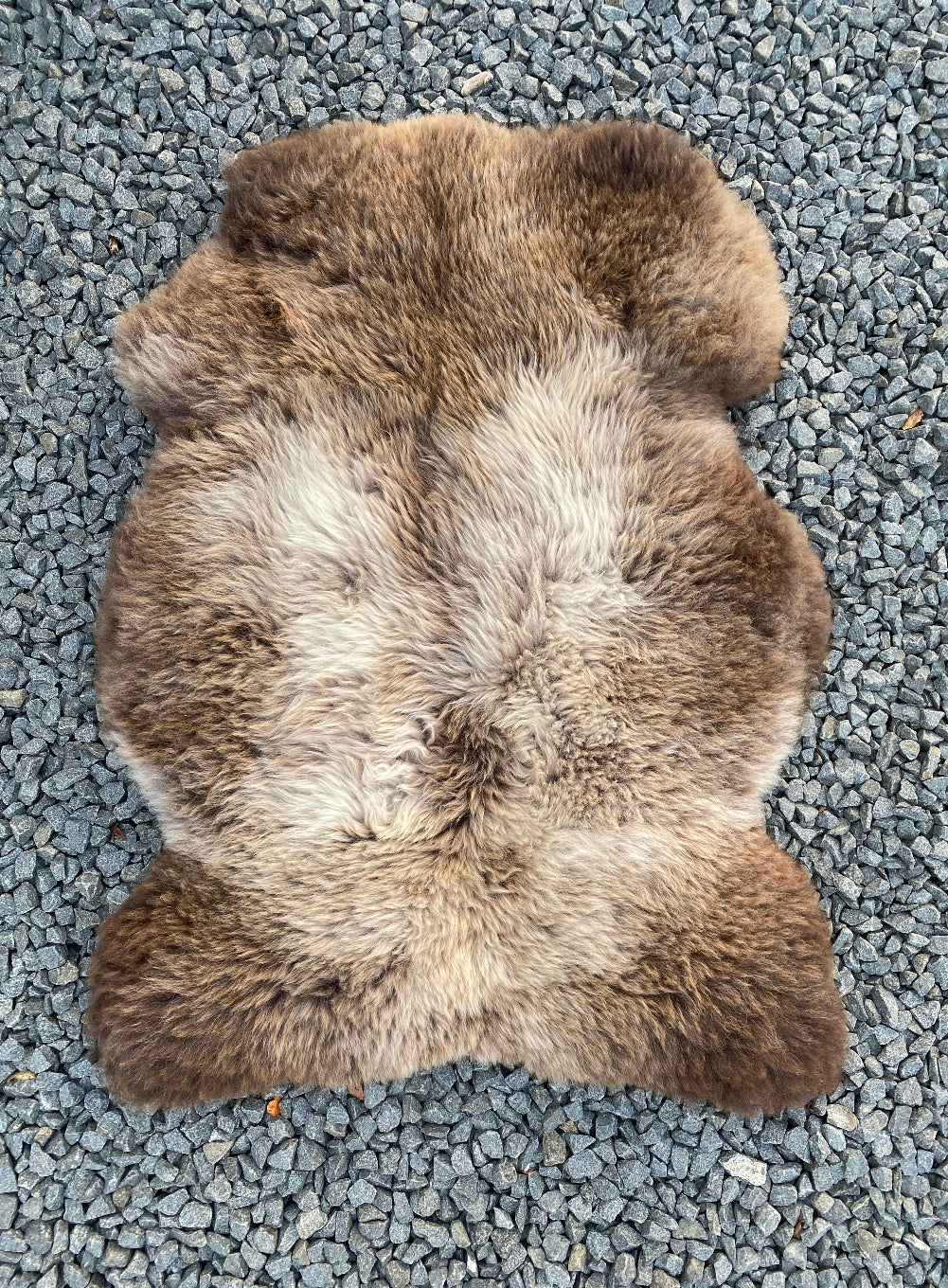 brown and cream sheepskin rug laid flat