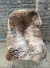 brown and cream sheepskin rug