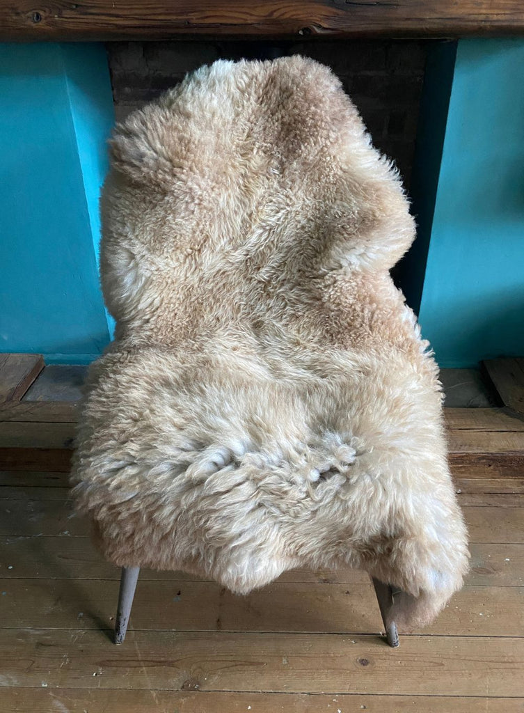 Caramel coloured sheepskin rug on chair