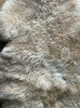 Caramel coloured sheepskin rug close up 