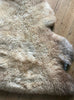 Caramel coloured sheepskin rug close up 
