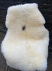 Cream sheepskin rug on chair