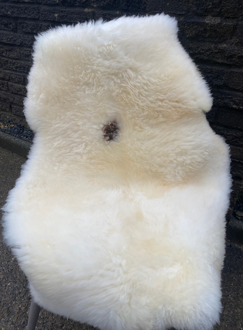Cream sheepskin rug on chair
