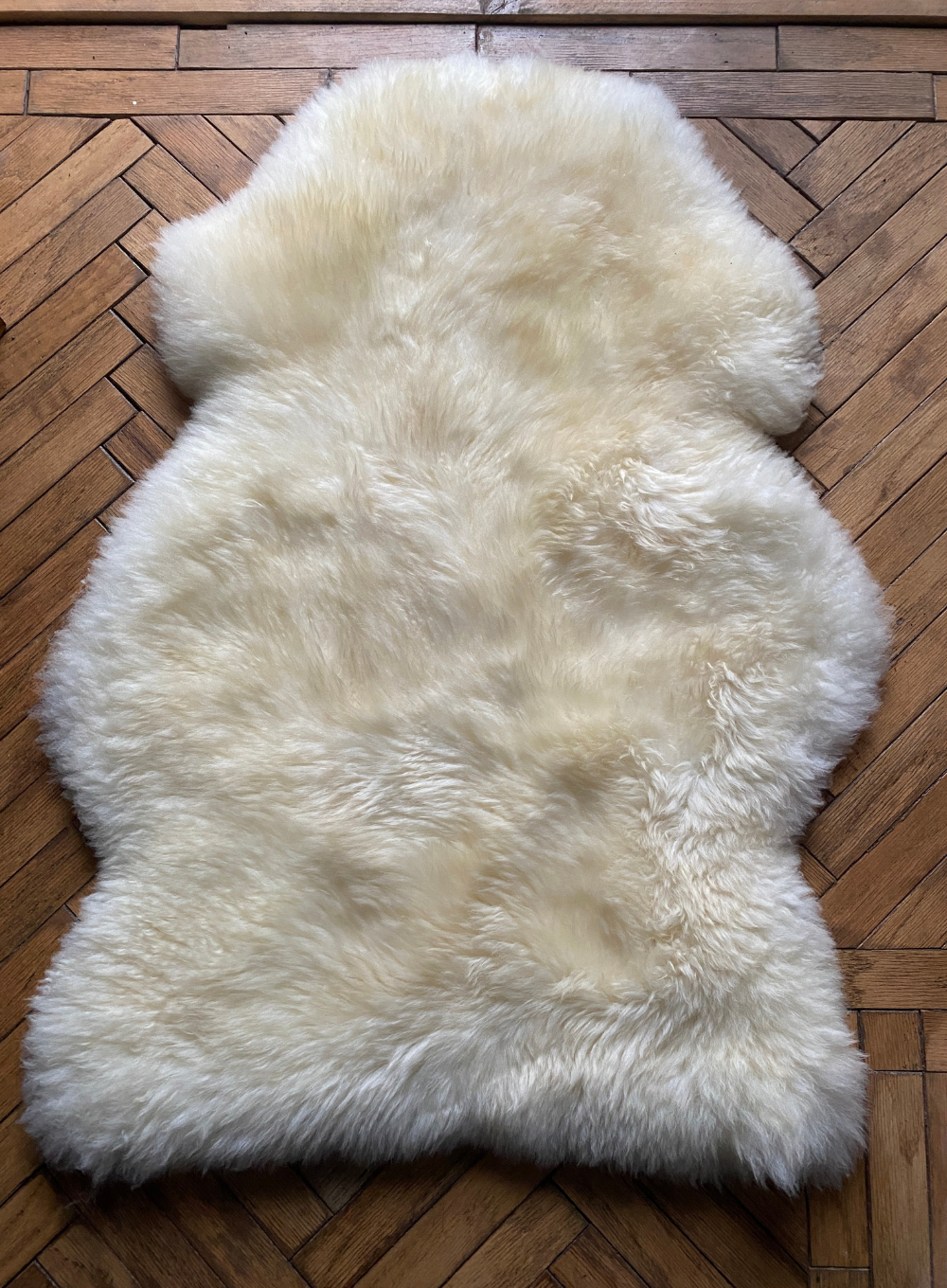 Cream sheepskin rug laid flat