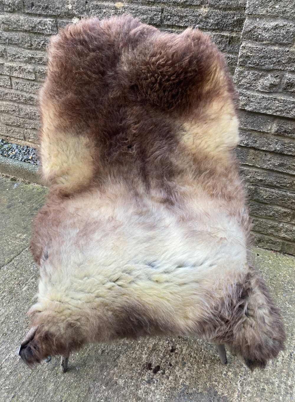 Brown and cream sheepskin rug on chair