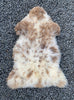 Brown and cream sheepskin rug laid flat