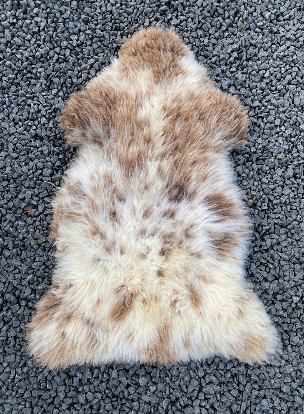 Brown and cream sheepskin rug laid flat