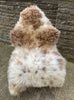Brown and cream sheepskin rug on chair