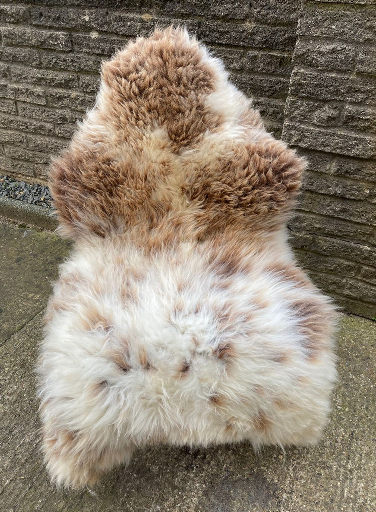 Brown and cream sheepskin rug on chair